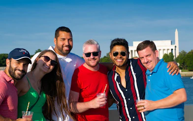 Group enjoying Boomerang Sightseeing Cruise on Potomac River with Lincoln Memorial in background.