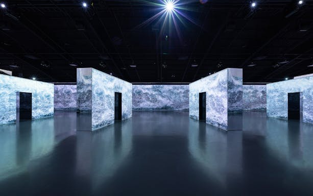 Immersive digital art installation at Arte Museum Jeju with illuminated walls.
