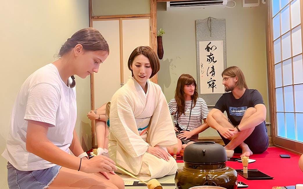 Instructor guiding participants in an Osaka tea ceremony.