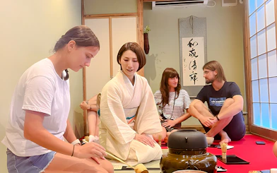 Instructor guiding participants in an Osaka tea ceremony.