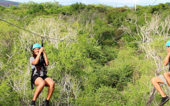 Ziplining through lush forest with modern braking system and expert guides.