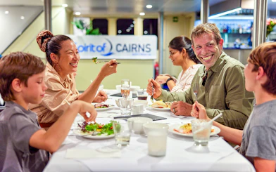 Family dining on Spirit of Cairns dinner cruise in Australia.