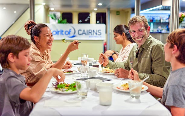 Family dining on Spirit of Cairns dinner cruise in Australia.