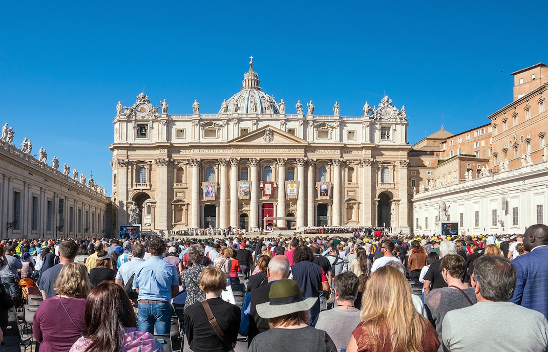 Tourists outside St. Peter's Basilica, Rome, Italy.