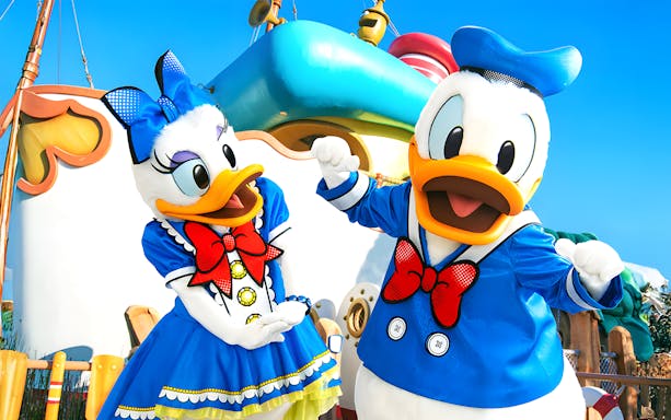 Characters in colorful outfits at Tokyo Disneyland.