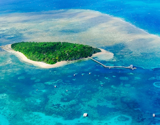 Aerial view of Green Island surrounded by coral reefs in the Great Barrier Reef, Australia.