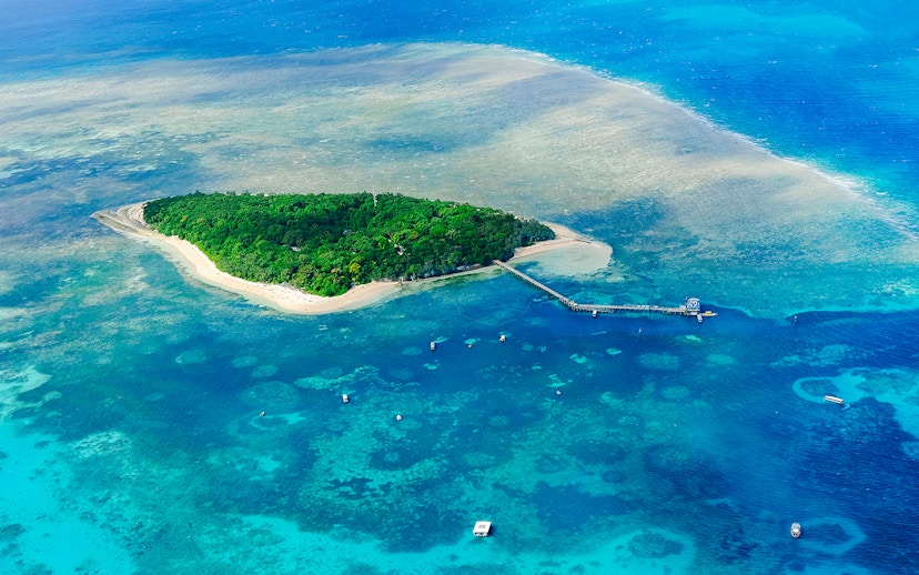 Aerial view of Green Island surrounded by coral reefs in the Great Barrier Reef, Australia.