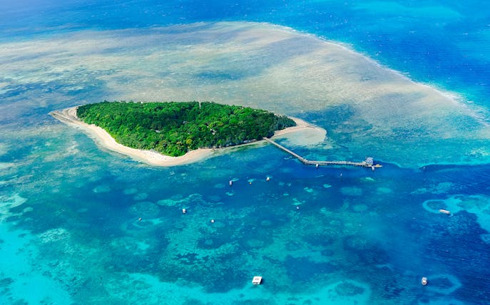 Aerial view of Green Island surrounded by coral reefs in the Great Barrier Reef, Australia.