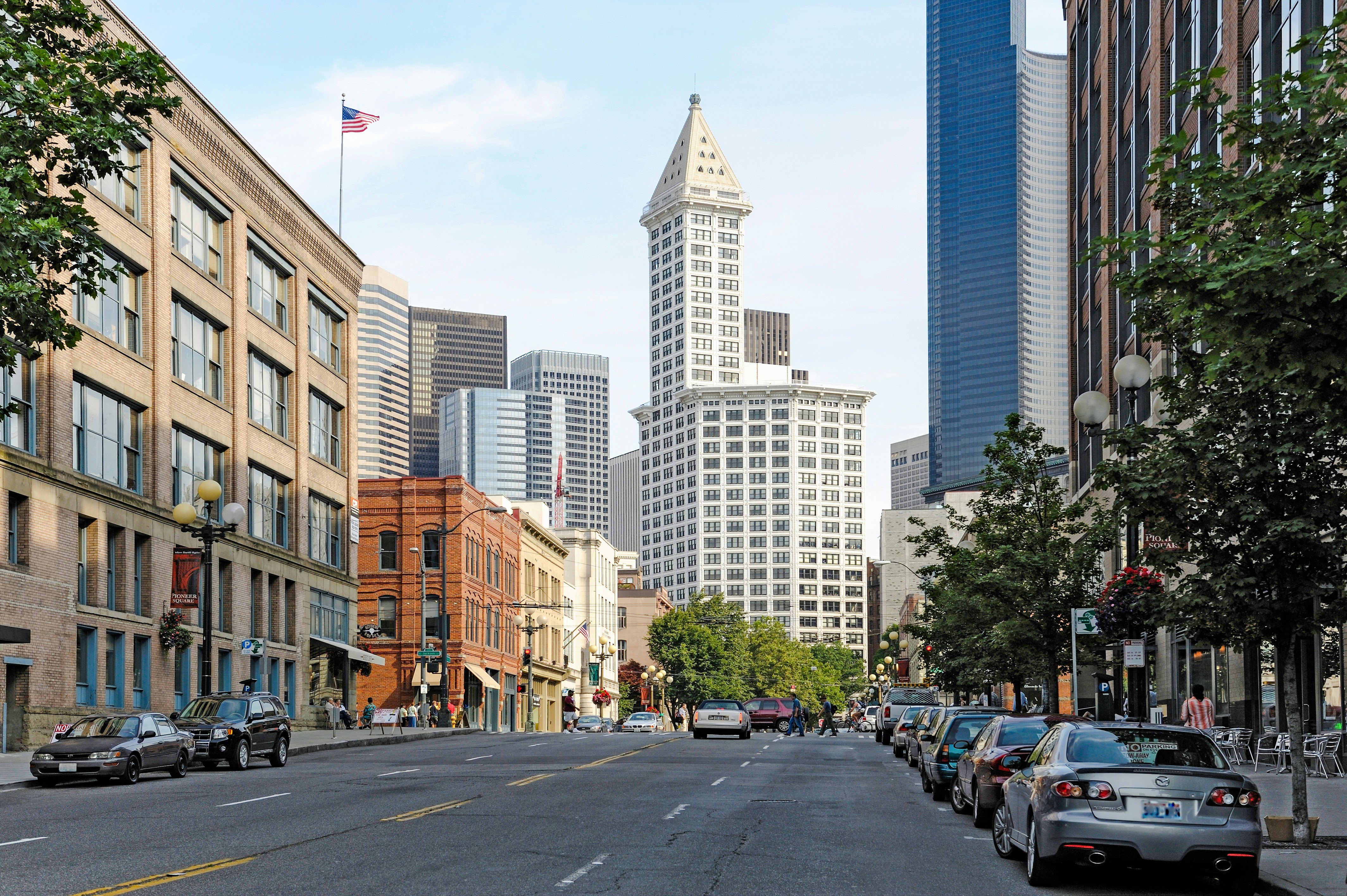 Smith Tower in downtown Seattle with surrounding buildings and street view.