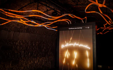 Illuminated sign with "Continue your journey" in an underground exhibit at Epic Museum.