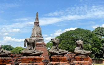 Ancient headless Buddha statues and stupa at Ayutthaya UNESCO World Heritage site, Thailand.
