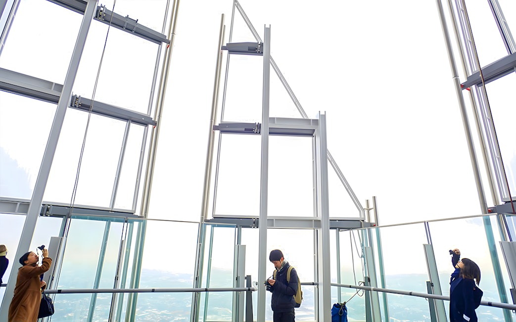 Visitors enjoying the view from The Shard's observation deck in London.