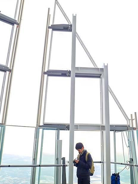 Visitors enjoying the view from The Shard's observation deck in London.