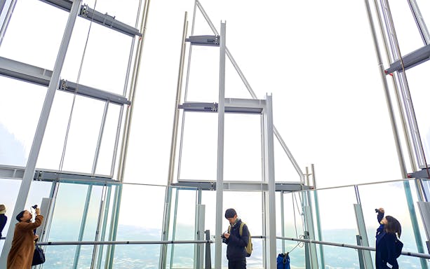 Visitors enjoying the view from The Shard's observation deck in London.