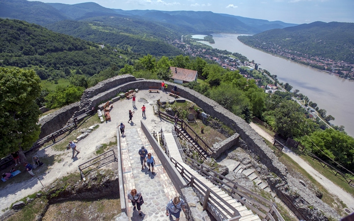 Guests exploring the panoramic view of the Danube Bend from a historic stone fortress.