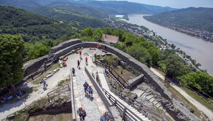 Guests exploring the panoramic view of the Danube Bend from a historic stone fortress.