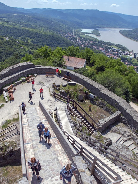 Guests exploring the panoramic view of the Danube Bend from a historic stone fortress.
