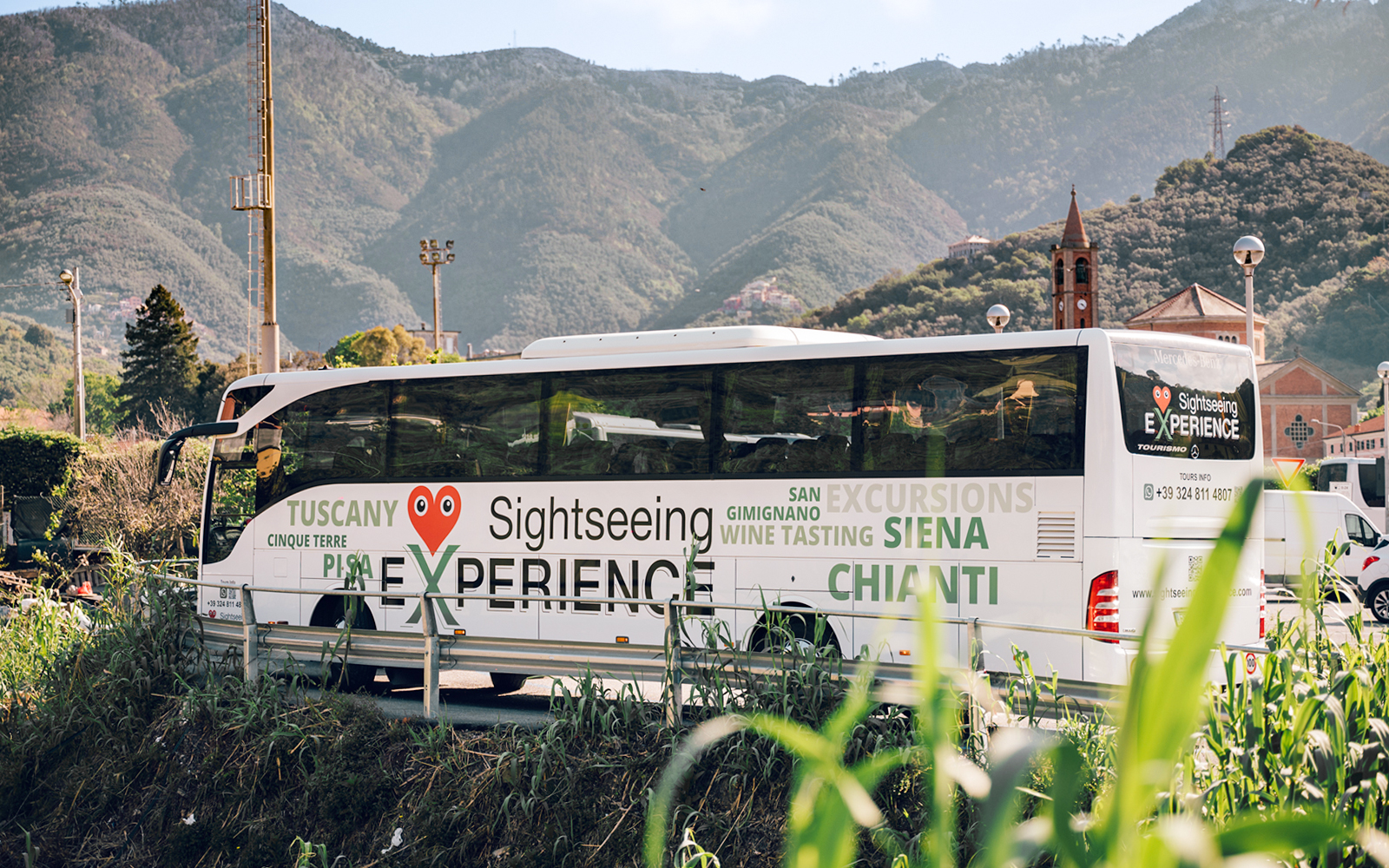 Sightseeing bus in Cinque Terre with mountain backdrop, part of Florence round-trip tour.