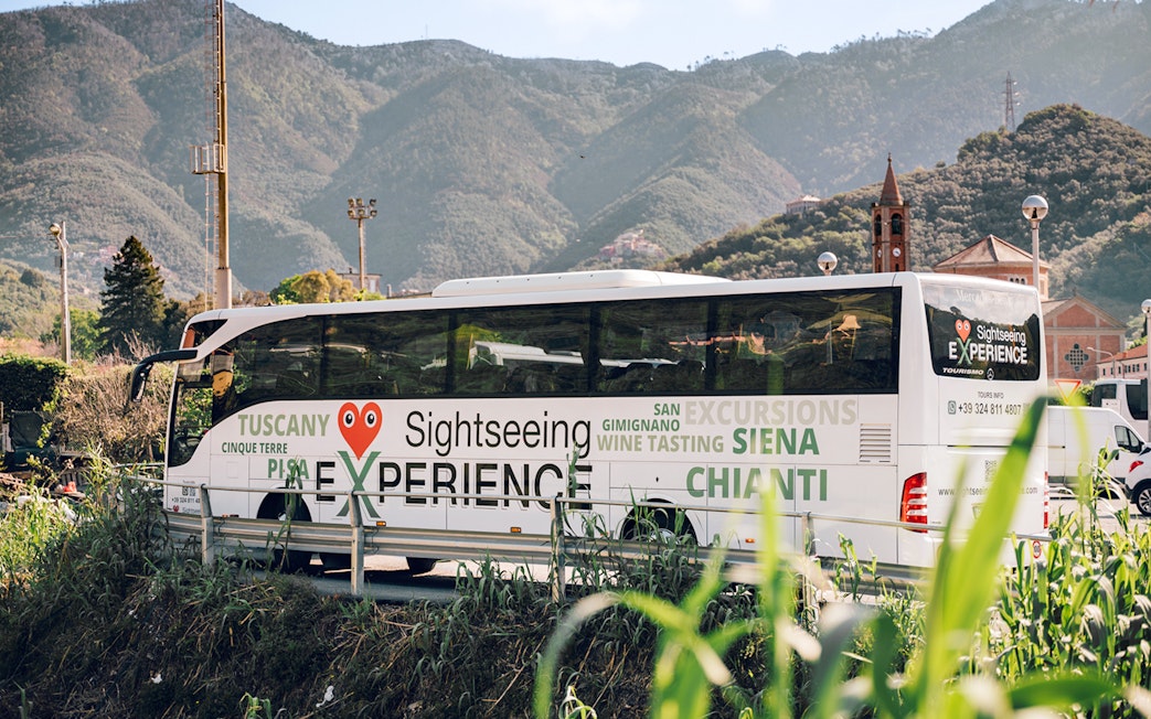 Sightseeing bus in Cinque Terre with mountain backdrop, part of Florence round-trip tour.