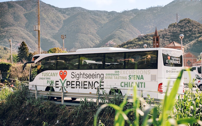 Sightseeing bus in Cinque Terre with mountain backdrop, part of Florence round-trip tour.