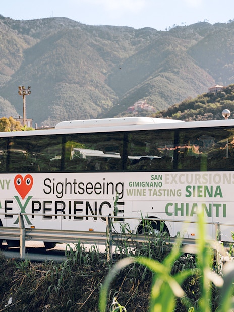 Sightseeing bus in Cinque Terre with mountain backdrop, part of Florence round-trip tour.