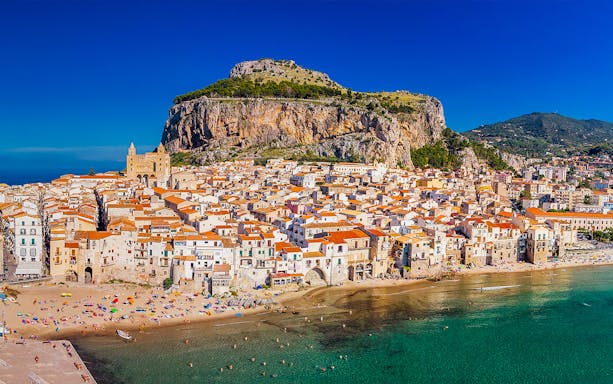 Aerial view of Lungomare Cefalù with historic buildings and beach, Sicily, Italy.