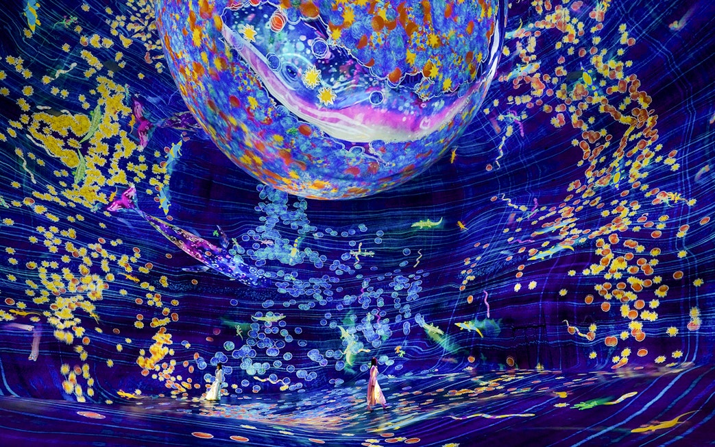 Interactive digital art installation at Team Lab Abu Dhabi with vibrant colors and floating elements.