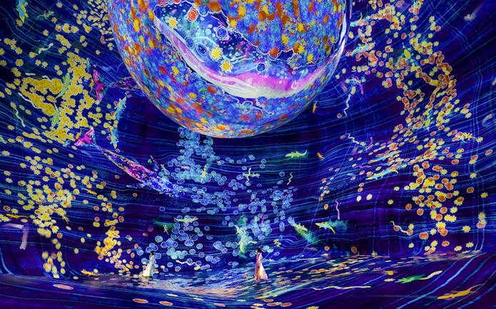 Interactive digital art installation at Team Lab Abu Dhabi with vibrant colors and floating elements.