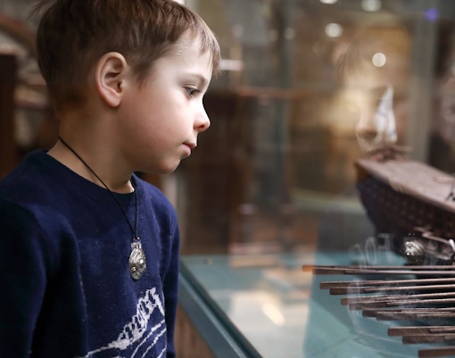 Child exploring exhibits at maritime museum.