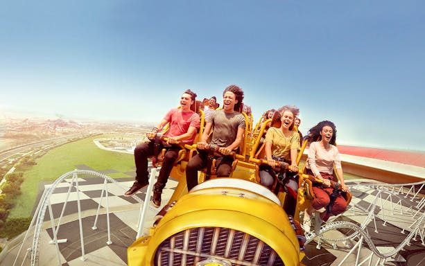 Visitors enjoying a roller coaster ride at Ferrari World Abu Dhabi.