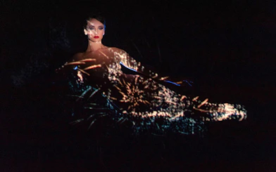 Performer at Crazy Horse Show with light projections, Paris.