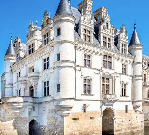 Loire Valley castle with turrets and moat, viewed on Paris to Loire Valley Castle Tours.