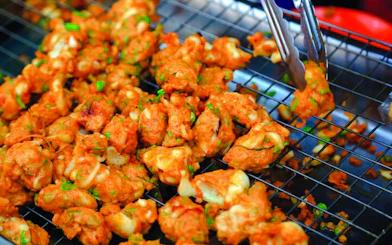 Thai street food being prepared at Amphawa Floating Markets during a private tour from Laem Chabang, Pattaya.