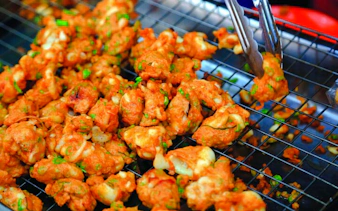 Thai street food being prepared at Amphawa Floating Markets during a private tour from Laem Chabang, Pattaya.