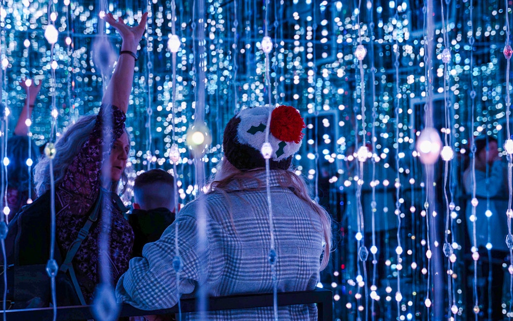 Guests exploring light installations at World of Illusion, Dublin.
