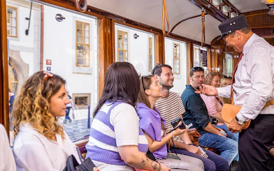 Tourists enjoying a guided tram tour in Prague.