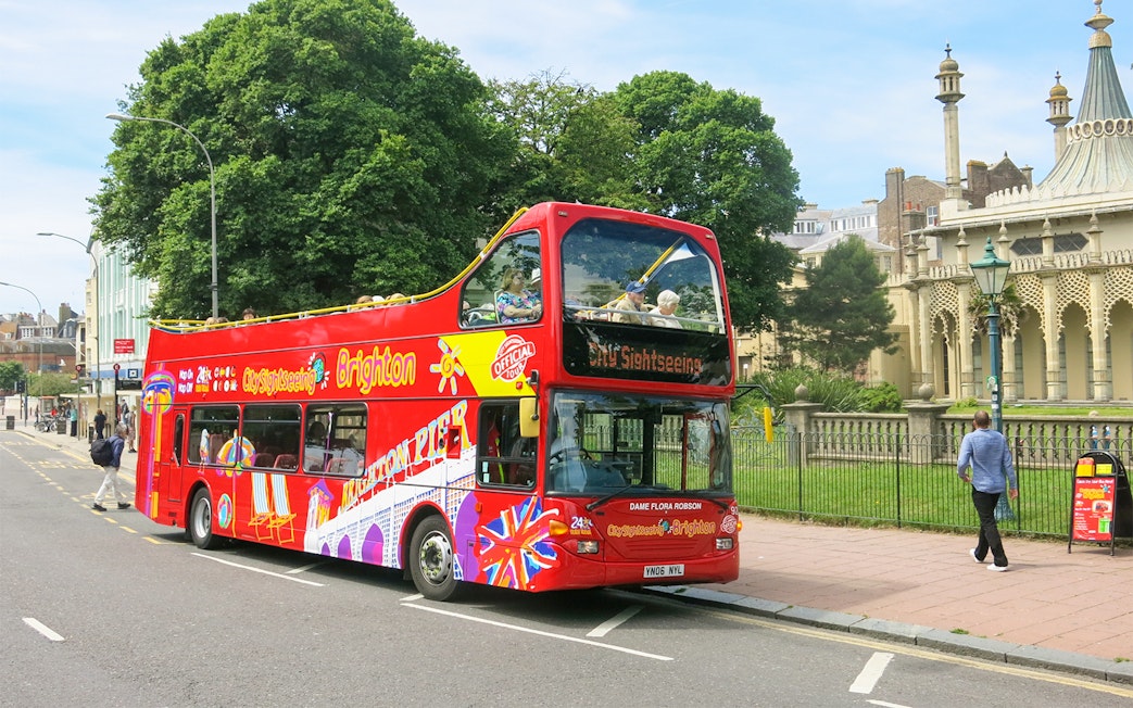 Open-top sightseeing bus near Royal Pavilion, Brighton.