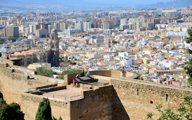Tourists enjoying city view from Gibralfaro Castle in Málaga, Spain.