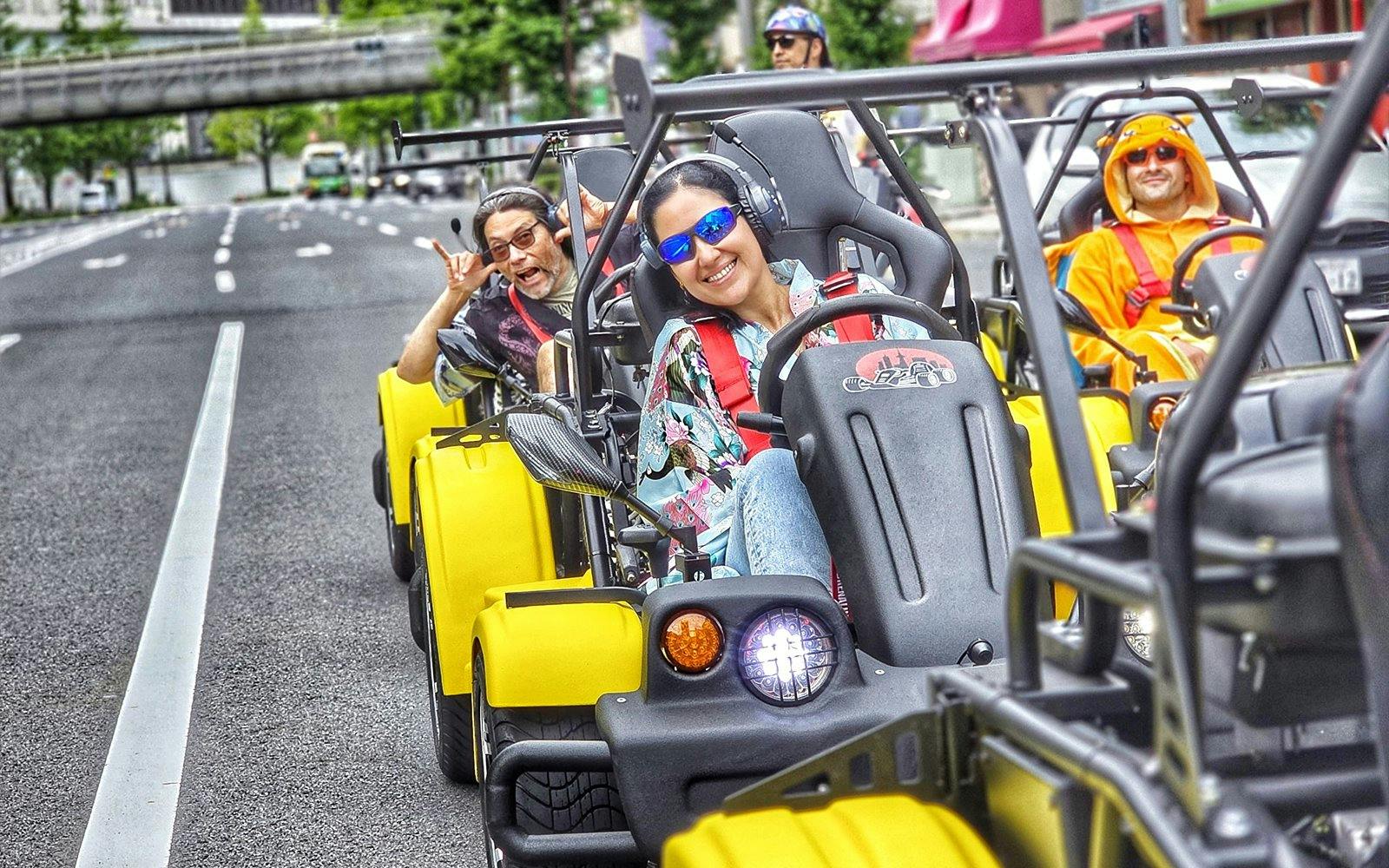 Group enjoying Uptown Go Kart Tour on city street.