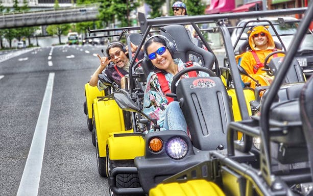 Group enjoying Uptown Go Kart Tour on city street.
