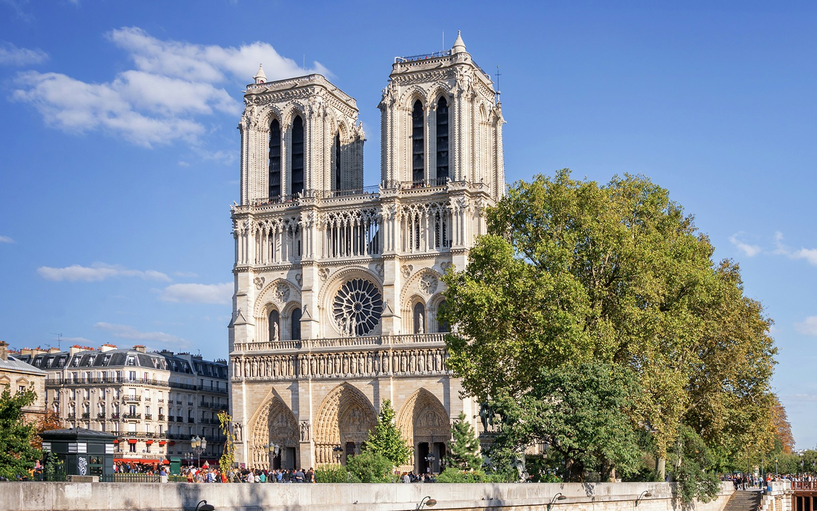 Tourists enjoying a 2.5-hour Seine River and Canal St Martin sightseeing cruise in Paris, with a view of iconic landmarks