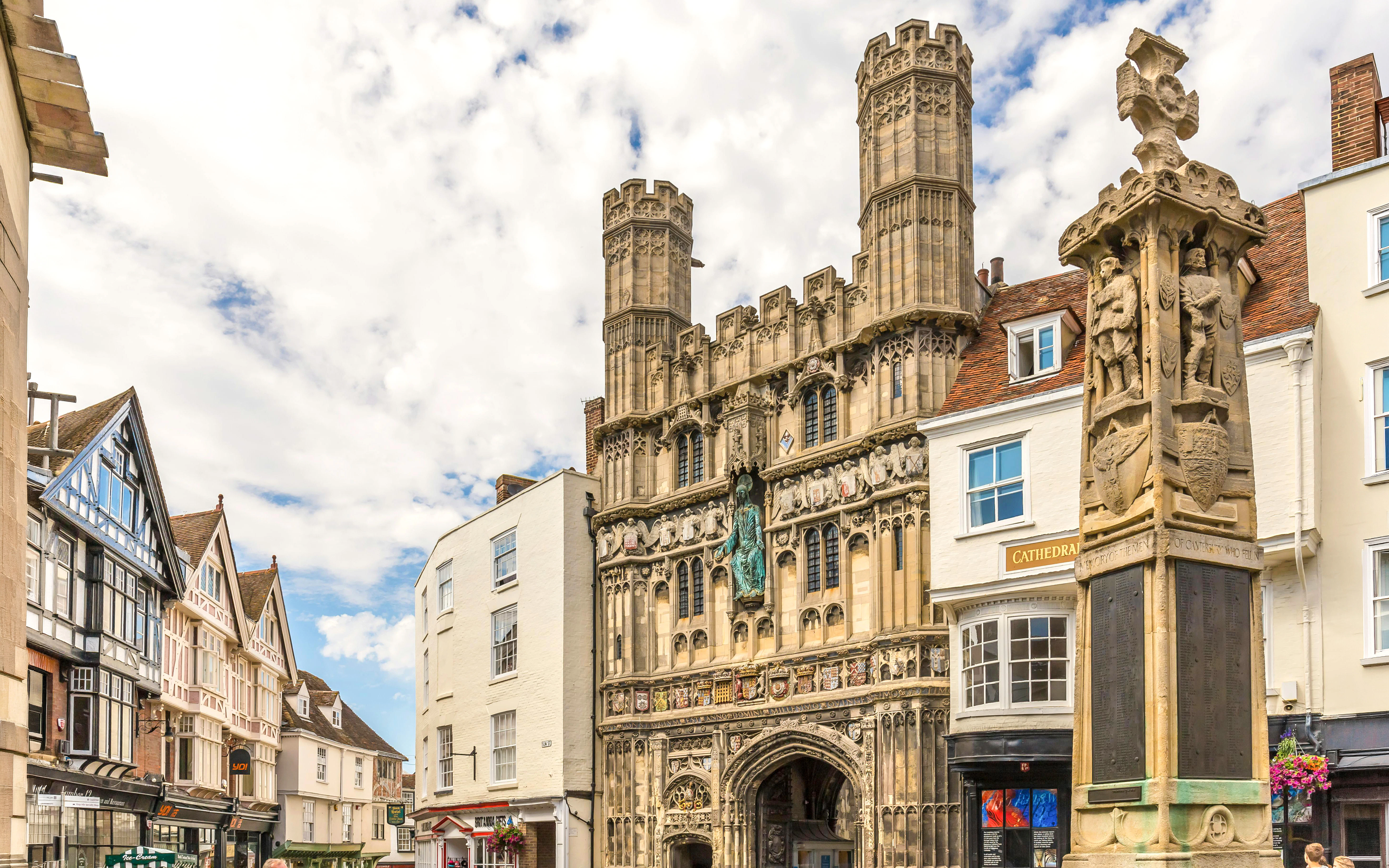 Christ Church Gate in Canterbury with nearby historic buildings and The Cathedral Gate Hotel.