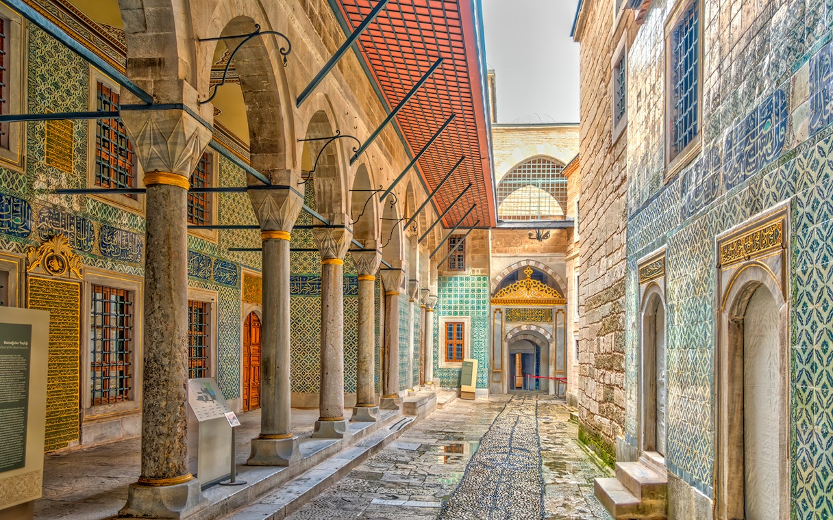 Topkapi Palace ornate corridor with arches and intricate tilework, Istanbul.