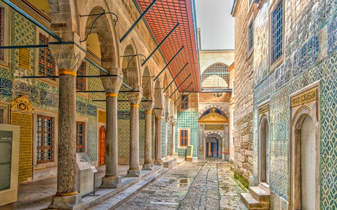 Topkapi Palace ornate corridor with arches and intricate tilework, Istanbul.