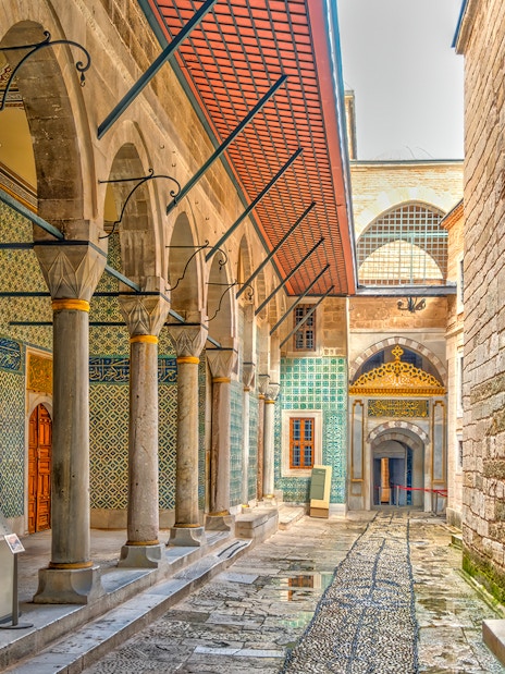 Topkapi Palace ornate corridor with arches and intricate tilework, Istanbul.