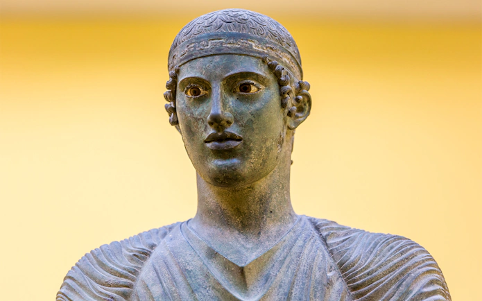 Ancient Greek bronze statue of a charioteer in Delphi, Greece.