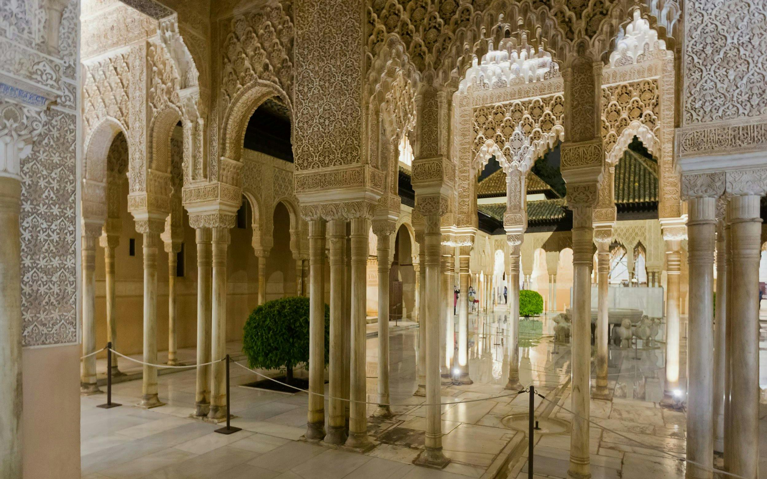 Courtyard of the Lions illuminated at night, Alhambra, Granada.