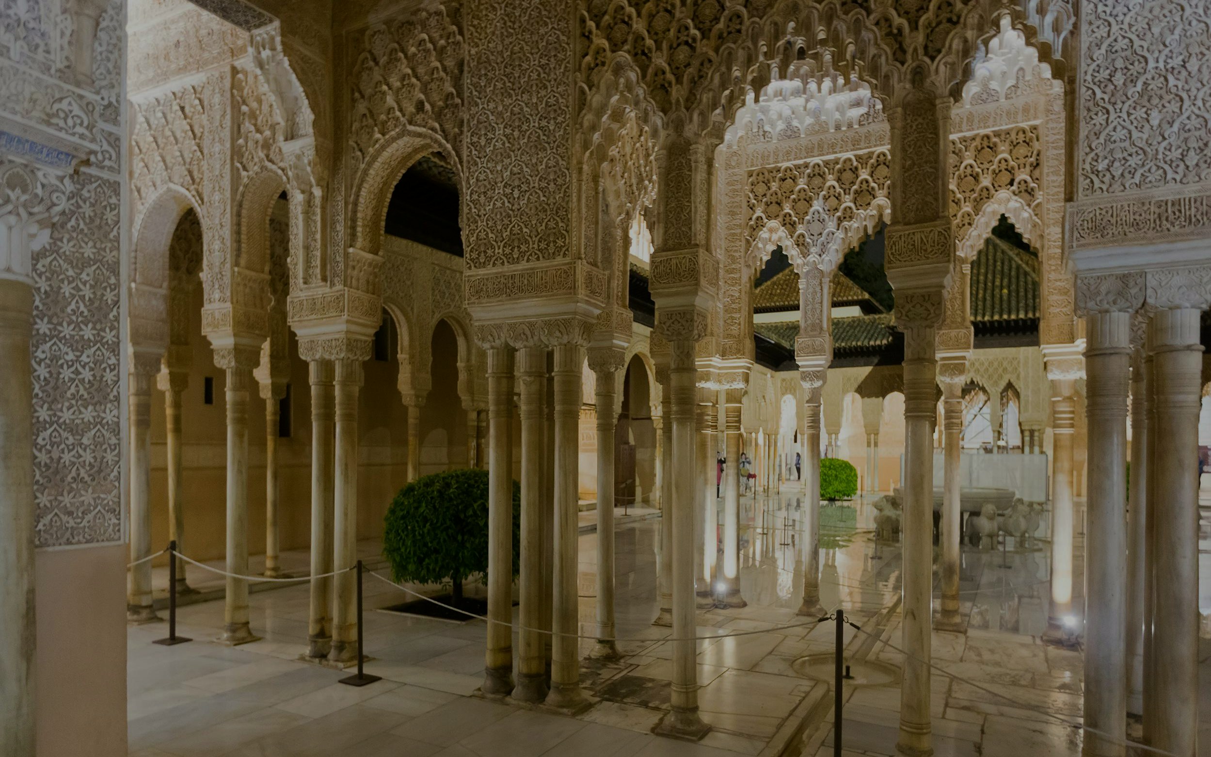 Courtyard of the Lions illuminated at night, Alhambra, Granada.
