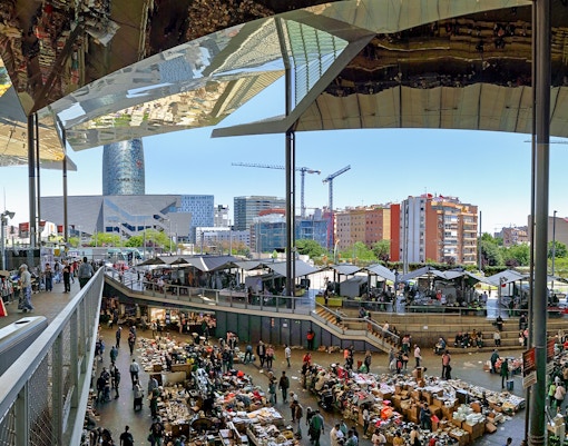 Encants Vells Flea Market stalls with shoppers browsing in Barcelona.