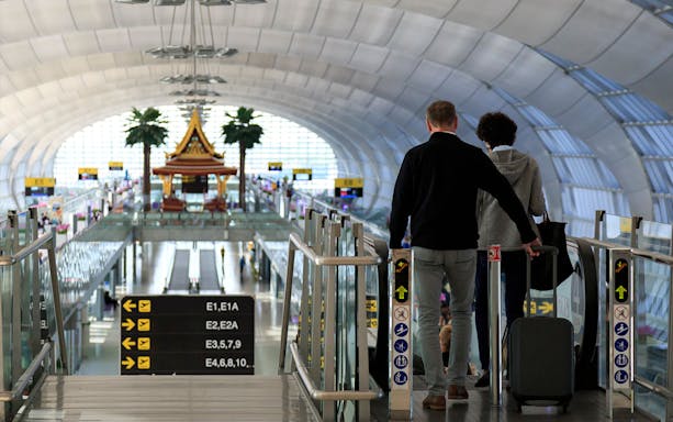Travelers at Suvarnabhumi Airport heading to immigration with VIP fast-track service.